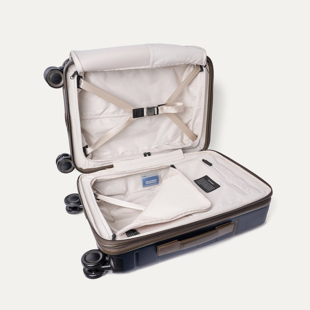 Open interior of the Carry-On from the Travelpro Platinum Reserve Carry-On / Medium / Large Hardside Set in Midnight Trail with hold-down straps