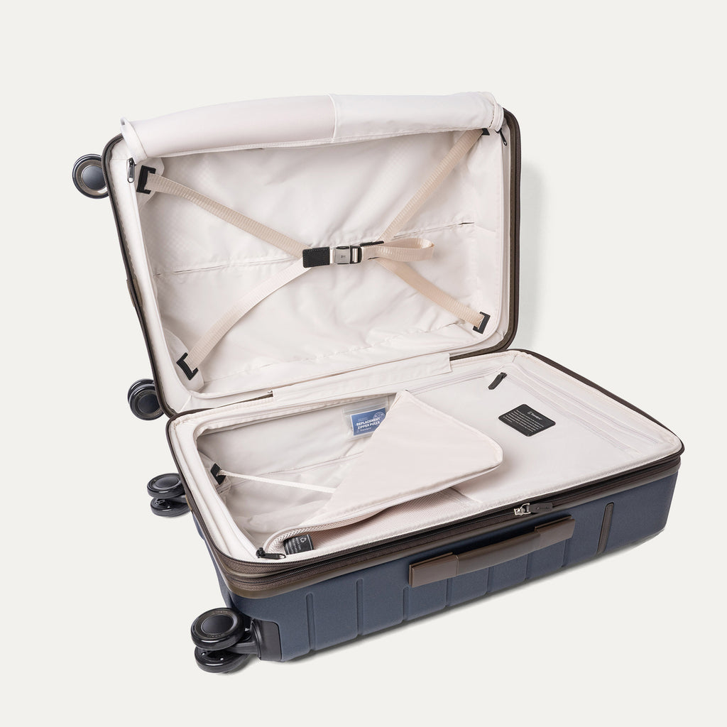 Open interior of the Medium Check-In from the Travelpro Platinum Reserve Carry-On / Medium / Large Hardside Set in Midnight Trail with hold-down straps