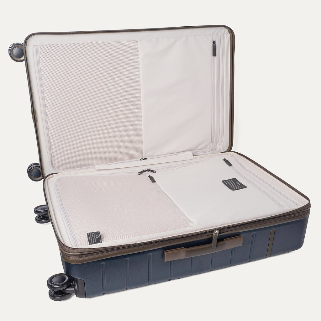 Open interior of the Large Check-In from the Travelpro Platinum Reserve Carry-On / Large Check-In Hardside Set in Midnight Trail showing the zippered divider panel