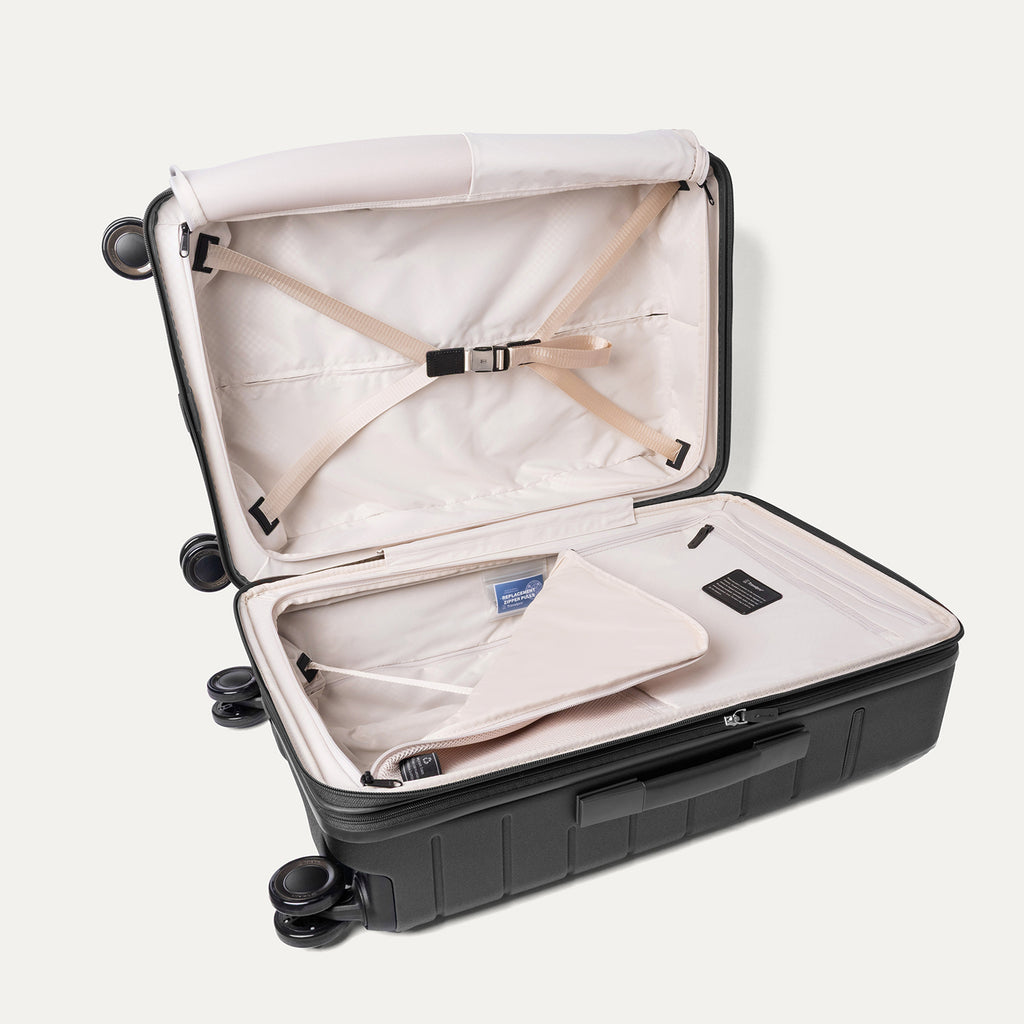 Open interior of the Medium Check-In from the Travelpro Platinum Reserve Medium / Large Check-In Hardside Set in Black Dust with hold-down straps