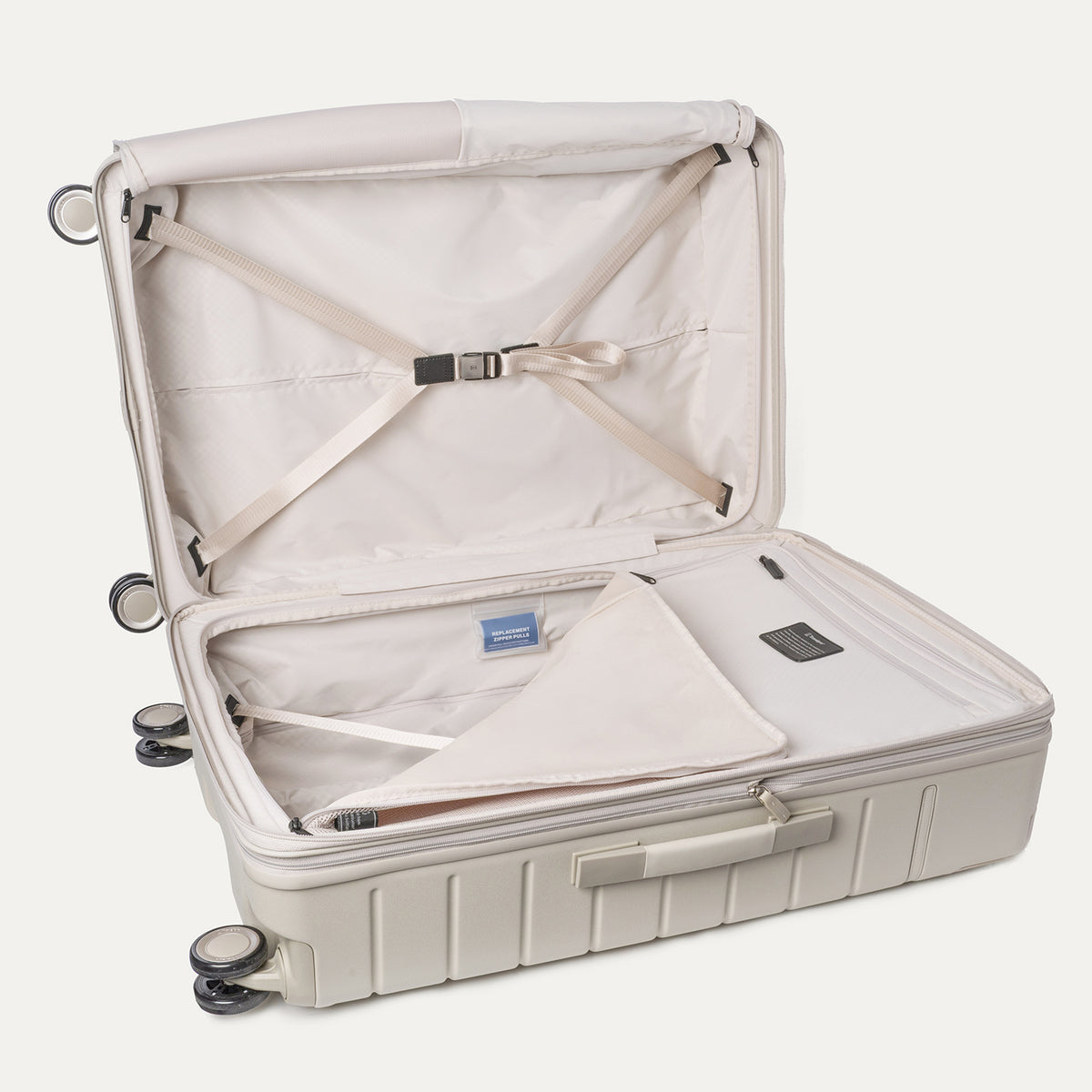 Open interior of the Large Check-In from the Travelpro Platinum Reserve Medium / Large Check-In Hardside Set in Sandstone with hold-down straps