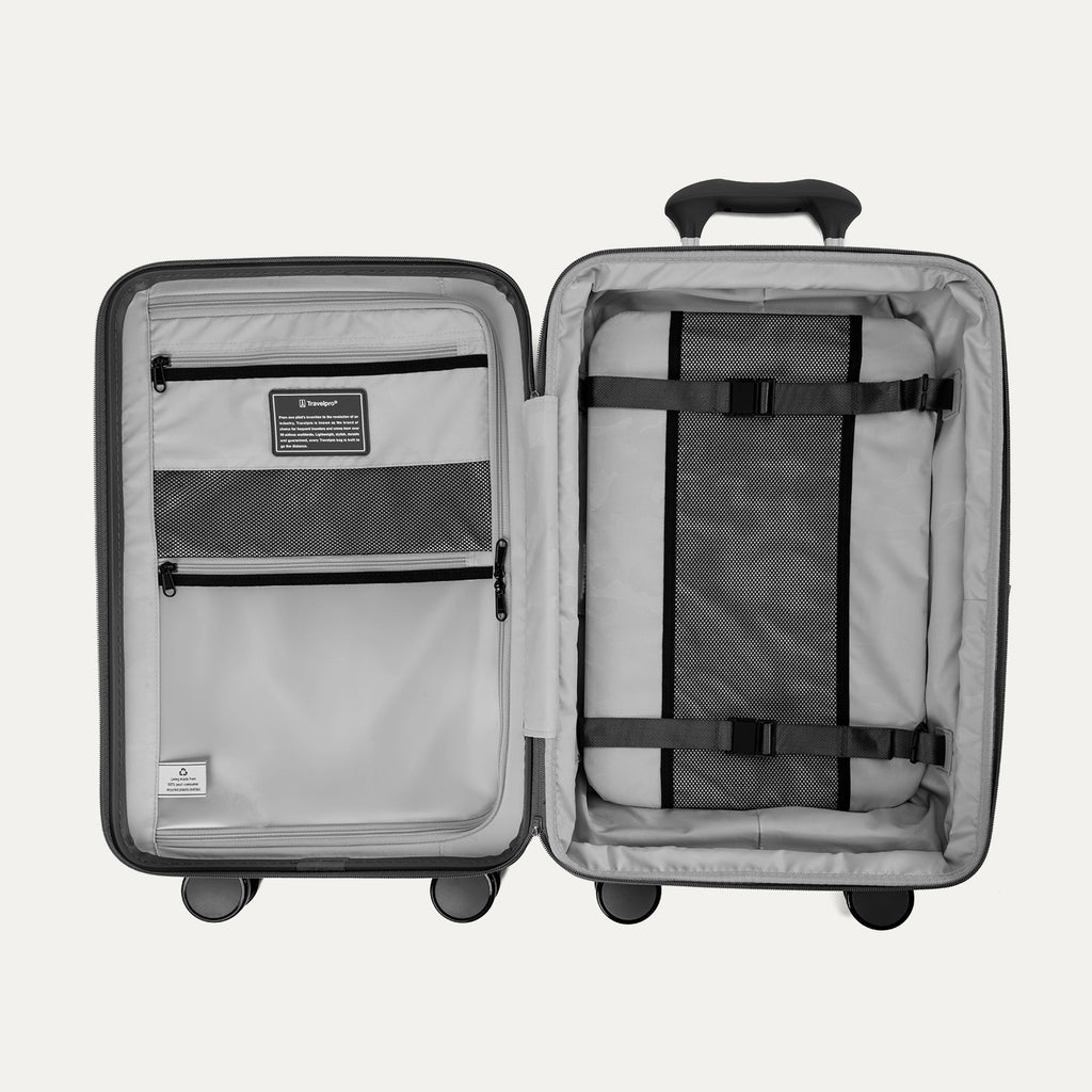 Interior view of the open Optima Expandable Compact Carry-On in Black, showcasing the spacious split-case organization with zippered mesh divider panels, compression straps, and interior accessory pockets.