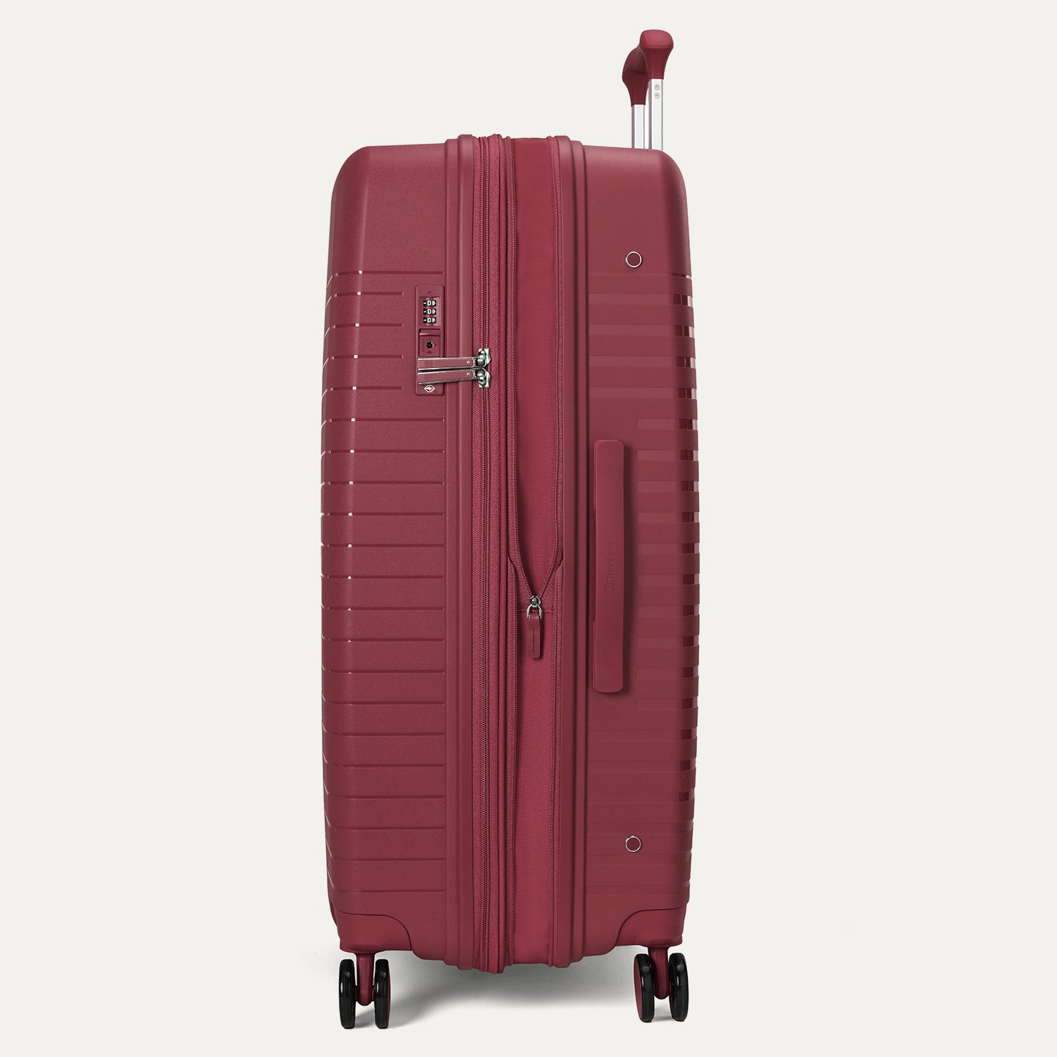 Side-profile view of the Optima Expandable Large Check-In hardside spinner in Tibetan Red, highlighting the side-mounted TSA-approved combination lock, sturdy side carry handle, and smooth-rolling spinner wheel system.
