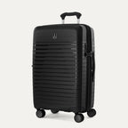 Three-quarter view of the Optima Expandable Medium Check-In hardside spinner in Black, showcasing the durable textured exterior, telescoping handle, and multi-directional spinner wheels.