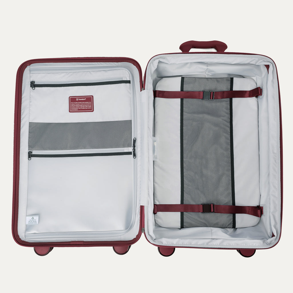Interior view of the open Optima Expandable Medium Check-In suitcase in Tibetan Red, showcasing the spacious split-case design with zippered mesh divider panels, compression straps, and interior accessory pockets.