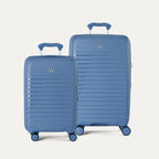 Side-by-side view of the Optima Expandable Compact Carry-On and Medium Check-In suitcases in Horizon Blue, displayed on a light gray background to highlight the size difference between the two pieces.