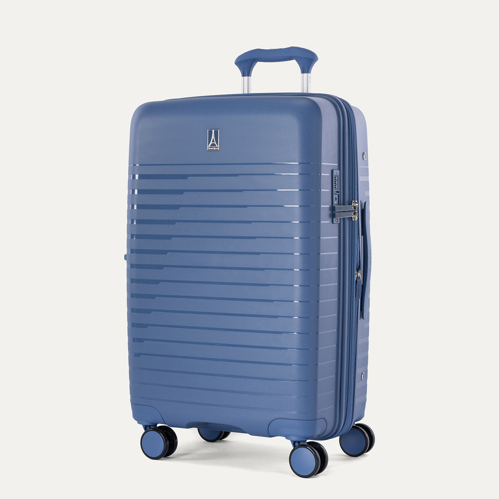 Three-quarter view of the Optima Expandable Compact Carry-On hardside spinner in Horizon Blue, showcasing the textured exterior, telescoping handle, and multi-directional spinner wheels.