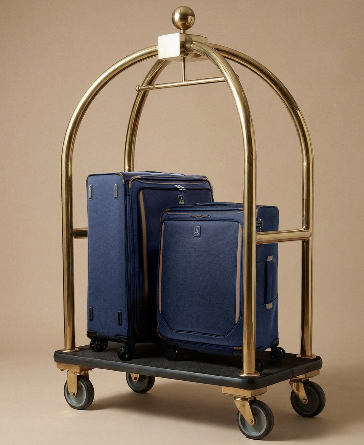 Gold luggage cart with blue suitcases on a beige background