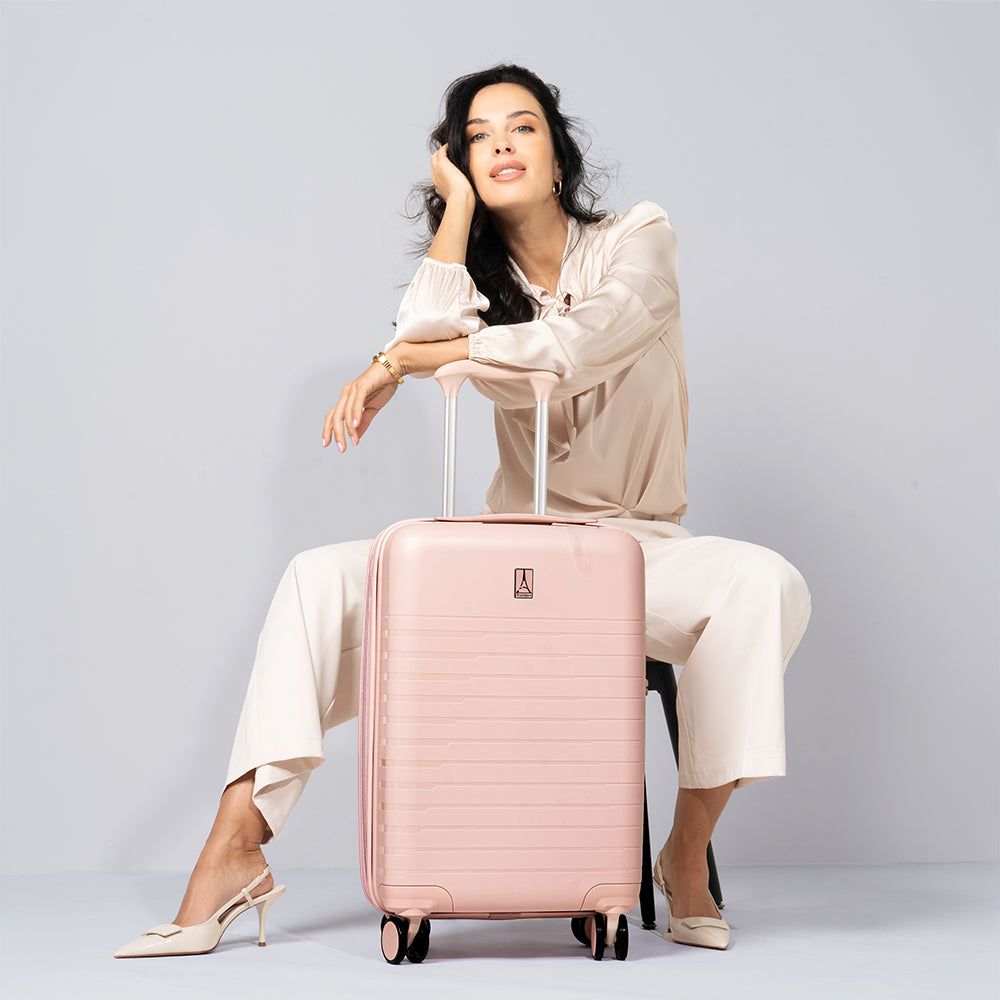 Woman sitting with pink optima luggage