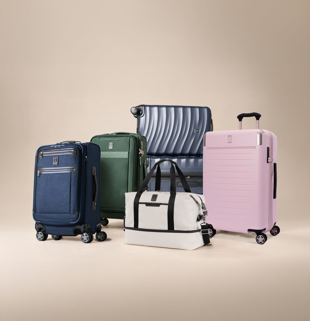 Blue, green, and pink luggage with a white duffel