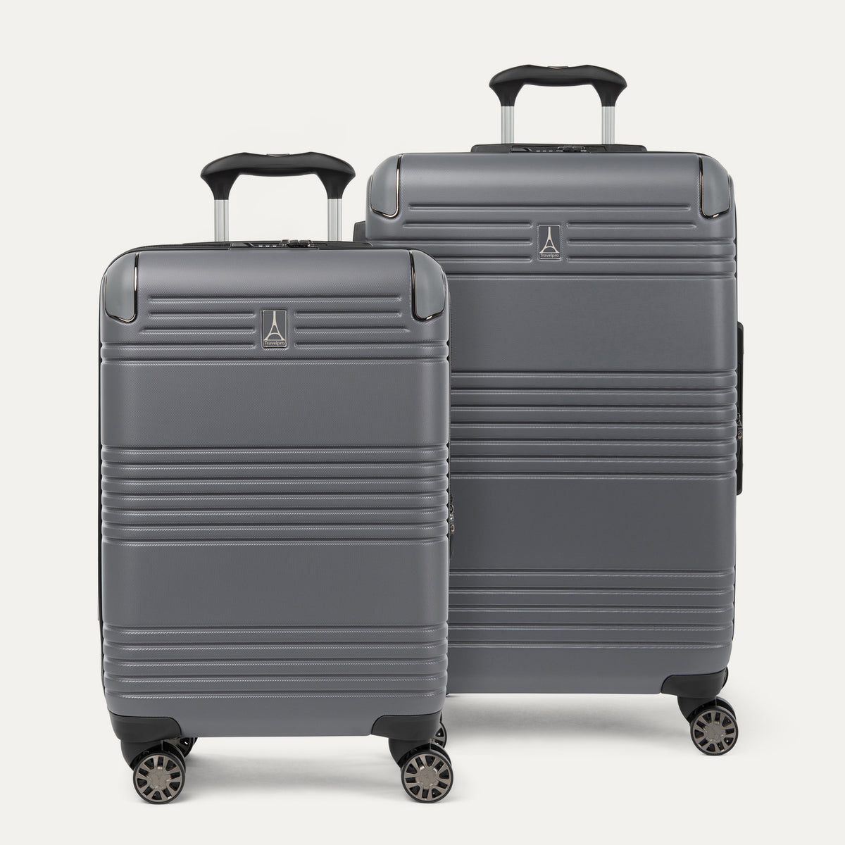 Front view of the Travelpro® Roundtrip® Carry-On and Medium Check-In Hardside Spinner Set in Gunmetal Grey, featuring a sleek textured finish and 360° spinner wheels.
