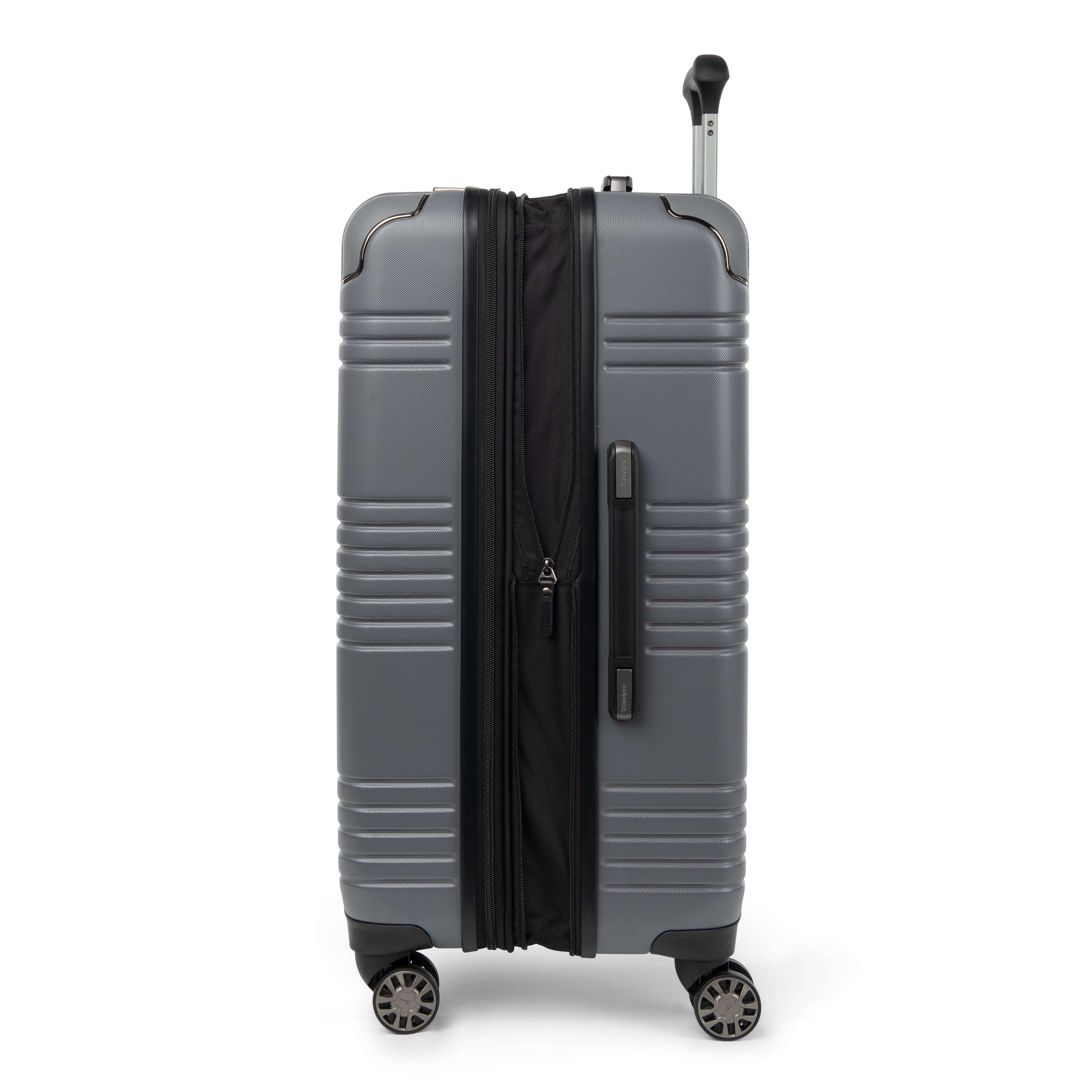 Side view of Travelpro Roundtrip Hardshell Medium Check‑In Suitcase in Gunmetal Gray, showing textured hardshell design, expansion zipper open, black telescoping handle, and four spinner wheels against white background.