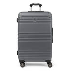 Front view of the Travelpro Roundtrip Medium Check-In Expandable Spinner in Gunmetal Gray, showing textured hardshell design with horizontal ridges, a small metallic logo, and four multi-directional wheels against a clean white background.