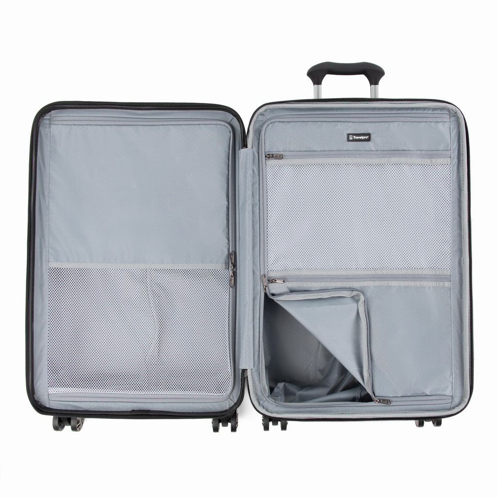 Interior view of the Travelpro Roundtrip Medium Check-In Expandable Spinner in Gunmetal Gray, showing the dual-compartment design with zippered mesh dividers and adjustable packing straps against a white background.