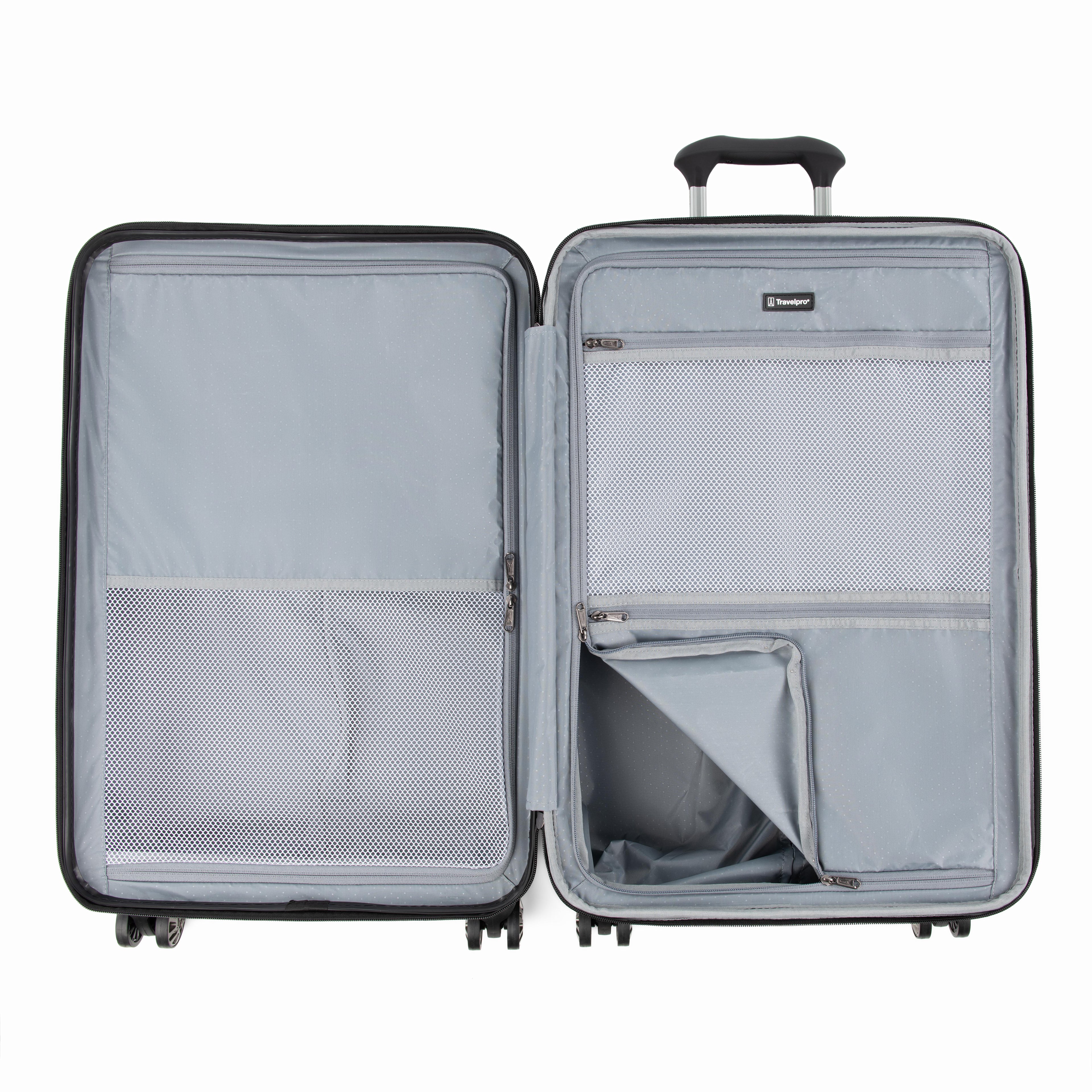 Interior view of the Travelpro Roundtrip Medium Check-In Expandable Spinner in Gunmetal Gray, showing the dual-compartment design with zippered mesh dividers and adjustable packing straps against a white background.
