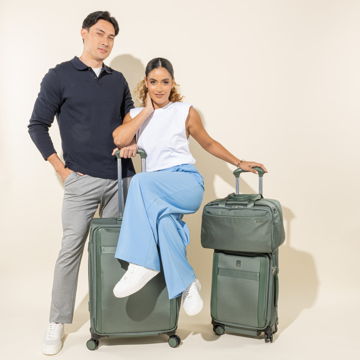 Man and Woman Standing with the VersaPack®+ Soft Sided Carry-On Spinner, Travel Tote with Trolley Sleeve, and Checked Luggage