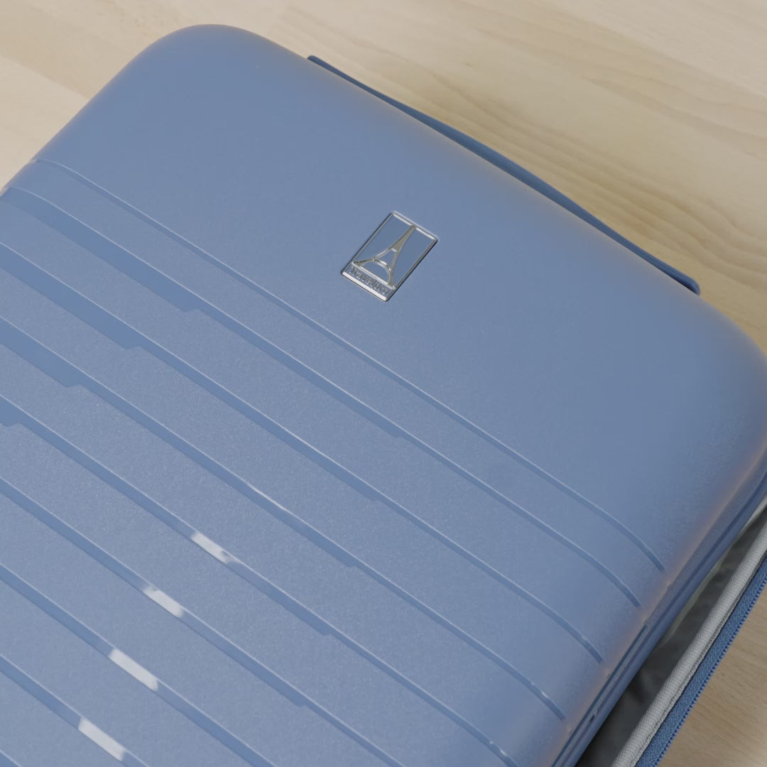 Close-up product demonstration video of the Travelpro Optima Expandable Spinner in Horizon Blue, highlighting the interior organization features, including the zippered mesh compartment and adjustable compression straps for efficient packing.
