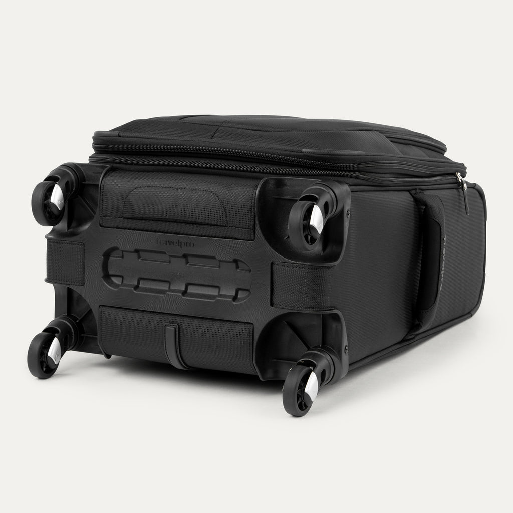 bottom view of the black travelpro maxlite® 5 carry-on spinner, showing the four 360-degree spinner wheels, the protective plastic bottom molding with the travelpro logo, and the durable fabric base.