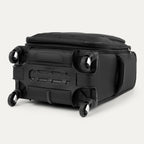 bottom view of the black travelpro maxlite® 5 carry-on spinner, showing the four 360-degree spinner wheels, the protective plastic bottom molding with the travelpro logo, and the durable fabric base.