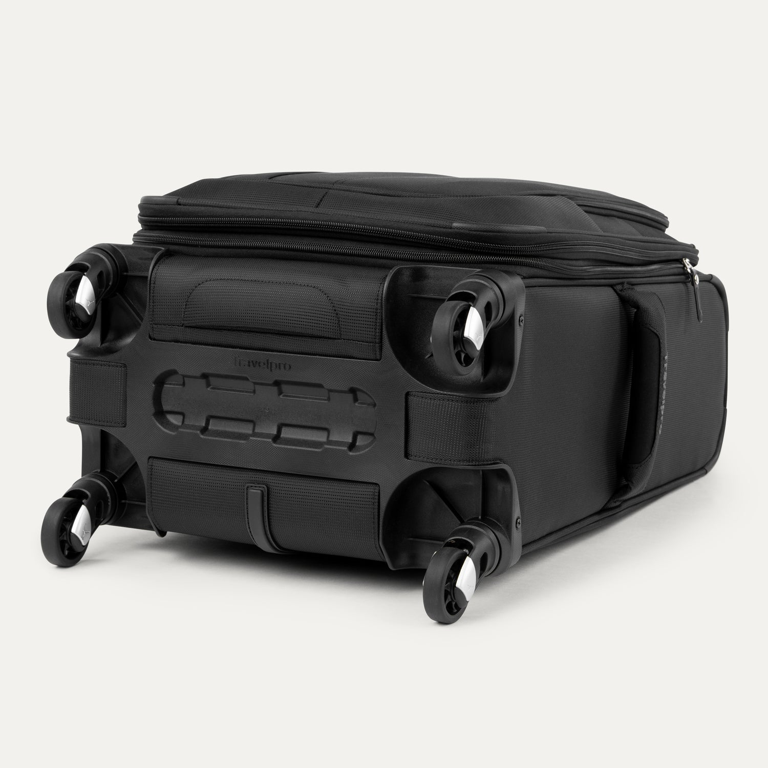 bottom view of the black travelpro maxlite® 5 carry-on spinner, showing the four 360-degree spinner wheels, the protective plastic bottom molding with the travelpro logo, and the durable fabric base.