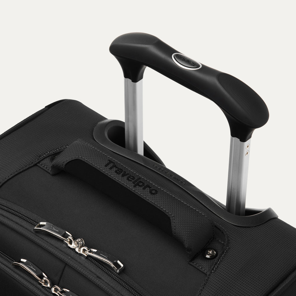 close-up view of the black travelpro maxlite® 5 carry-on spinner, showing the cushioned top carry handle with the travelpro logo and the rubberized contour grip on the powerscope lite extension handle.