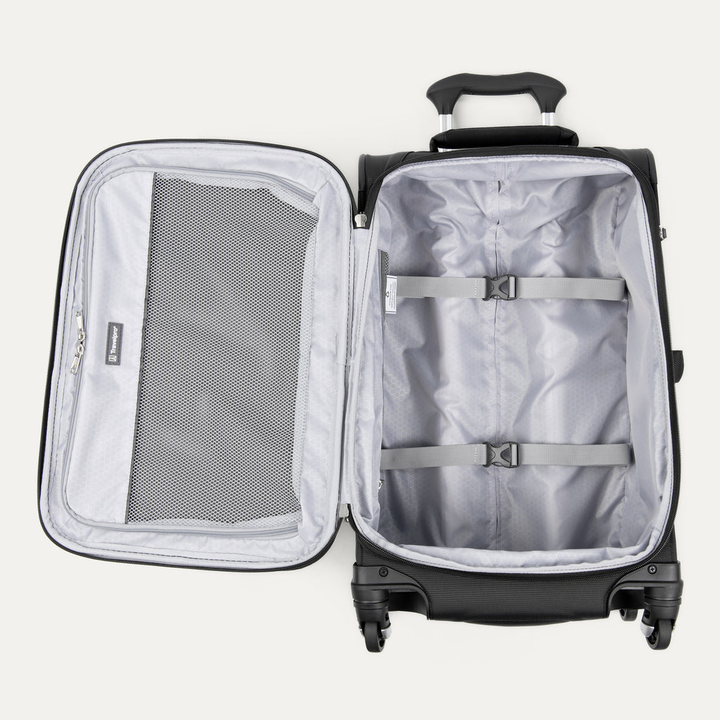 interior view of the open black travelpro maxlite® 5 carry-on spinner, showing the lightweight grey lining, a large zippered mesh lid pocket, and adjustable hold-down straps to keep clothes organized.