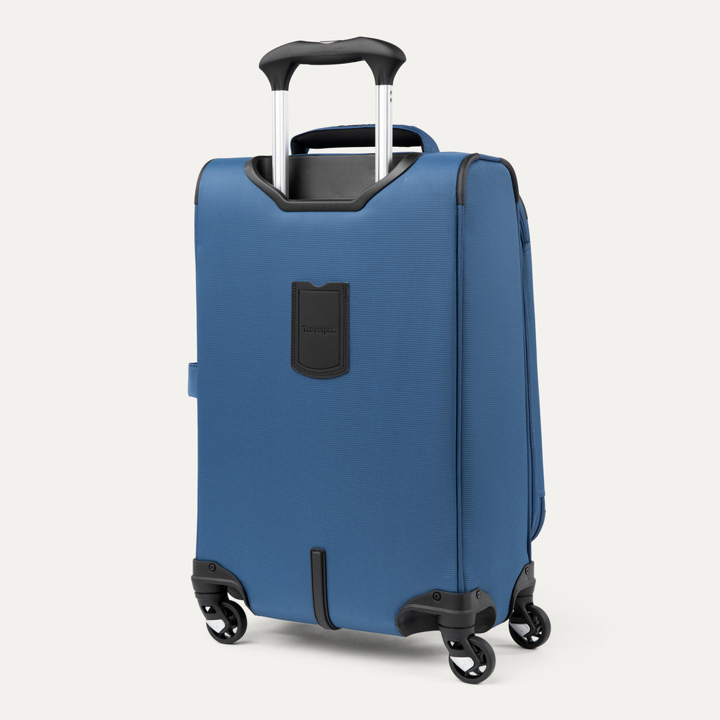 rear-angled view of the ensign blue travelpro maxlite® 5 carry-on spinner, showing the integrated trolley strap for secure stacking on larger luggage and the height-adjustable powerscope lite extension handle.