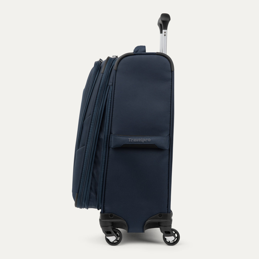 side profile view of the midnight blue travelpro maxlite® 5 carry-on spinner, showing the tapered expansion zipper for extra packing capacity, the side carry handle, and the 360-degree spinner wheels.