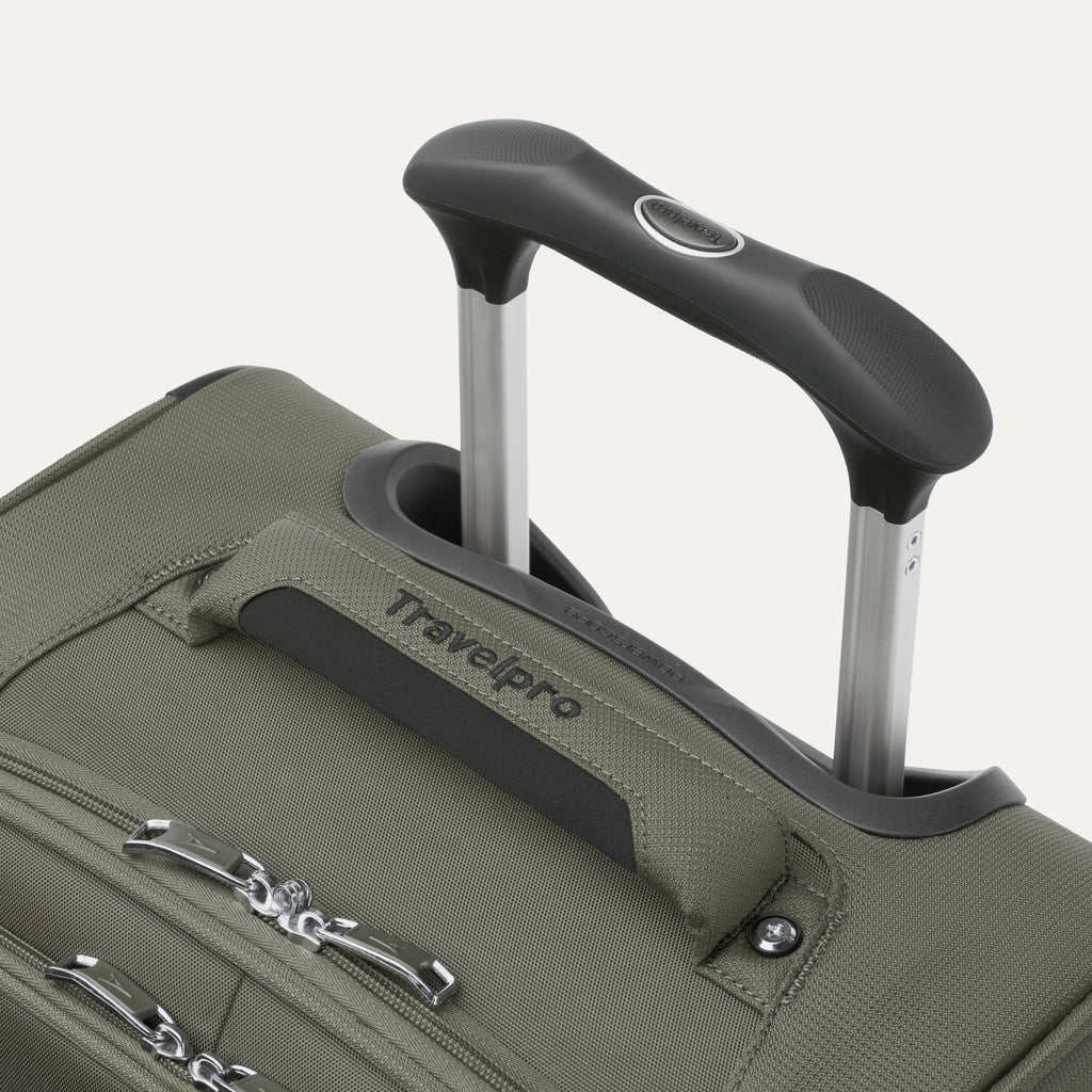 close-up view of the slate green travelpro maxlite® 5 carry-on spinner, showing the cushioned top carry handle with the travelpro logo and the rubberized contour grip on the powerscope lite extension handle.
