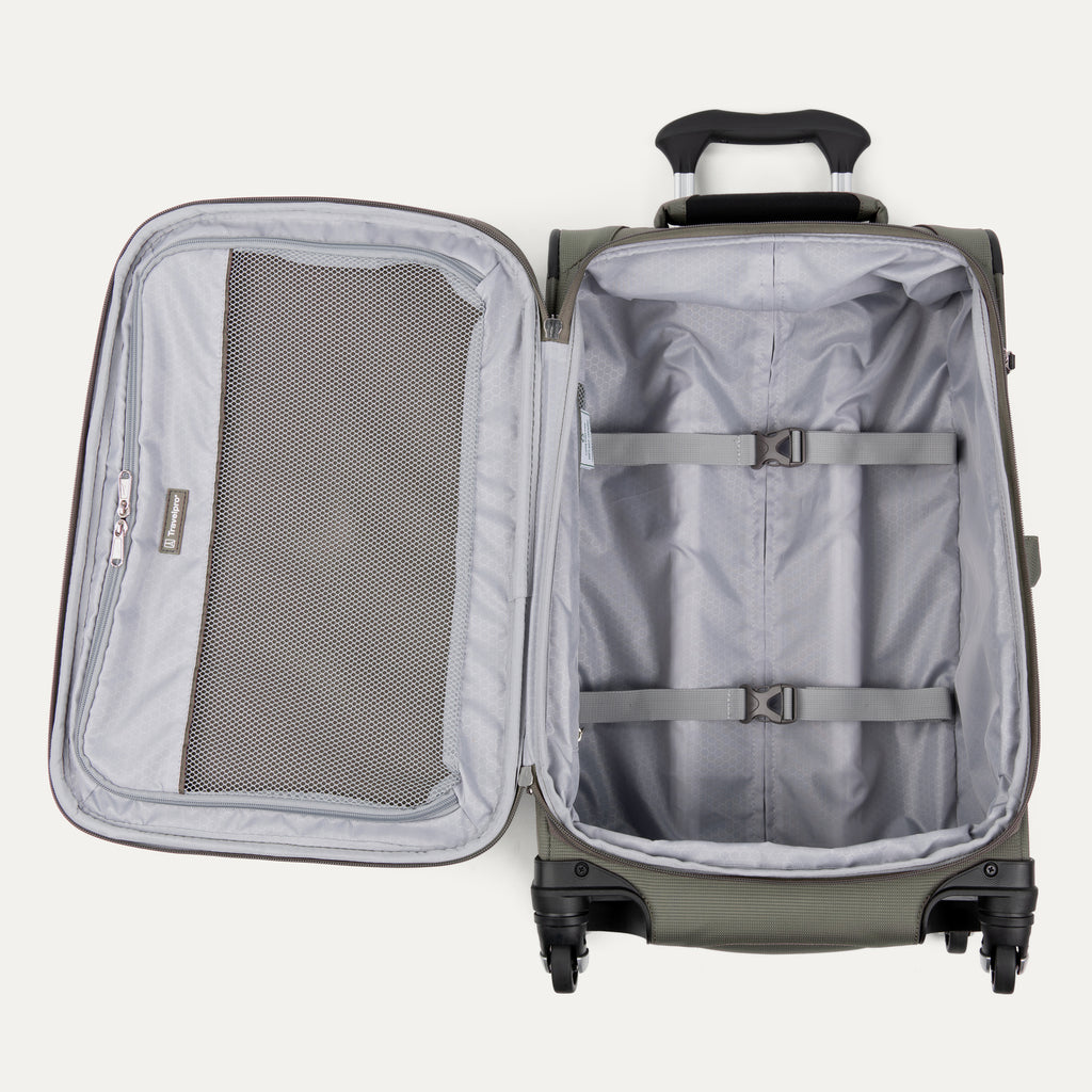 interior view of the open slate green travelpro maxlite® 5 carry-on spinner, showing the lightweight grey lining, a large zippered mesh lid pocket, and adjustable hold-down straps to keep clothes organized.