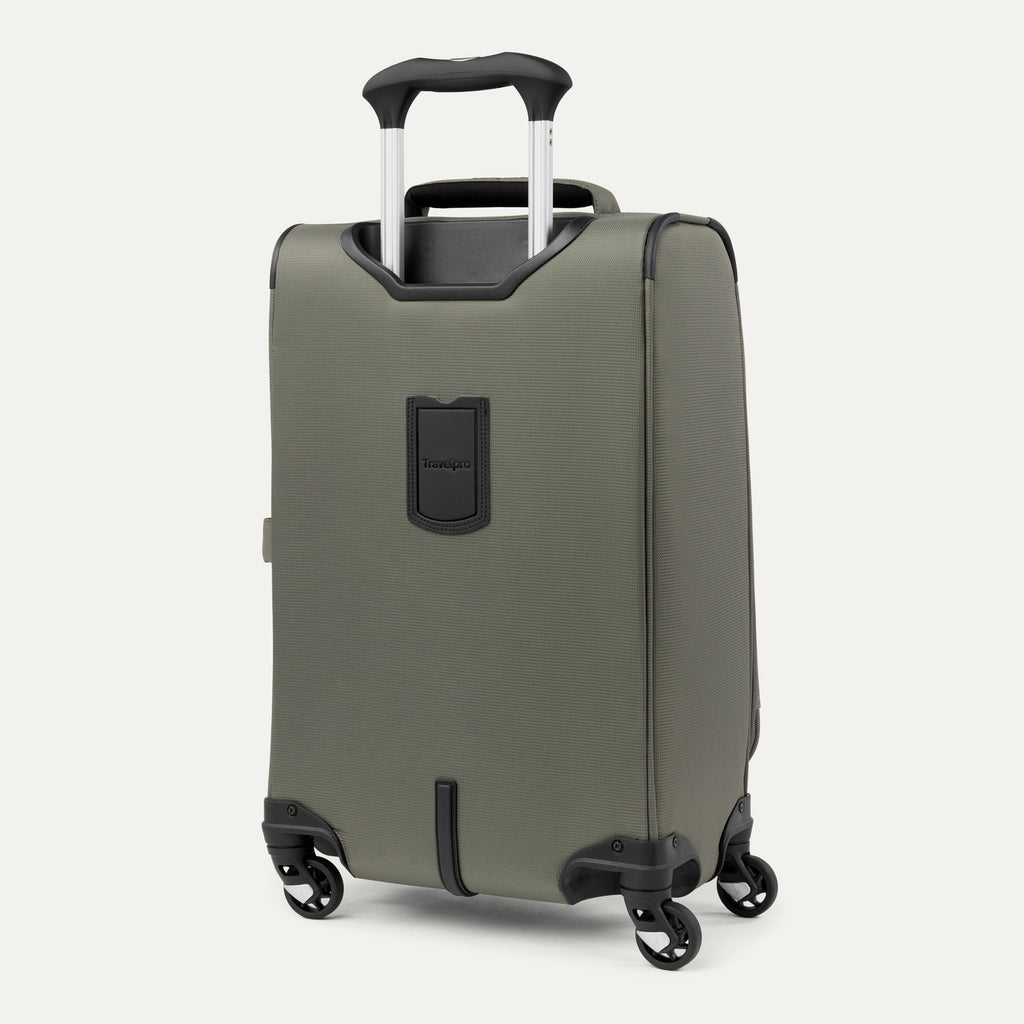 side-angled rear view of the slate green travelpro maxlite® 5 carry-on spinner, showing the integrated trolley strap for secure stacking and the height-adjustable powerscope lite extension handle.