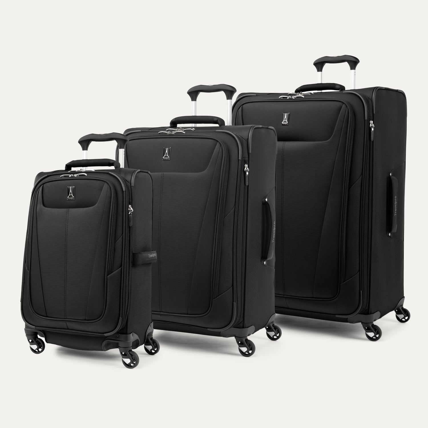 a three-piece luggage set featuring the shadow black travelpro maxlite® 5 carry-on, medium, and large expandable spinners arranged together in a group view.