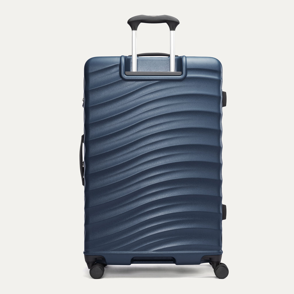 rear view of the large midnight blue travelpro maxlite® air v2 hardside spinner, showing the durable polycarbonate shell with its signature wave design and the powerscope lite extension handle fully deployed.