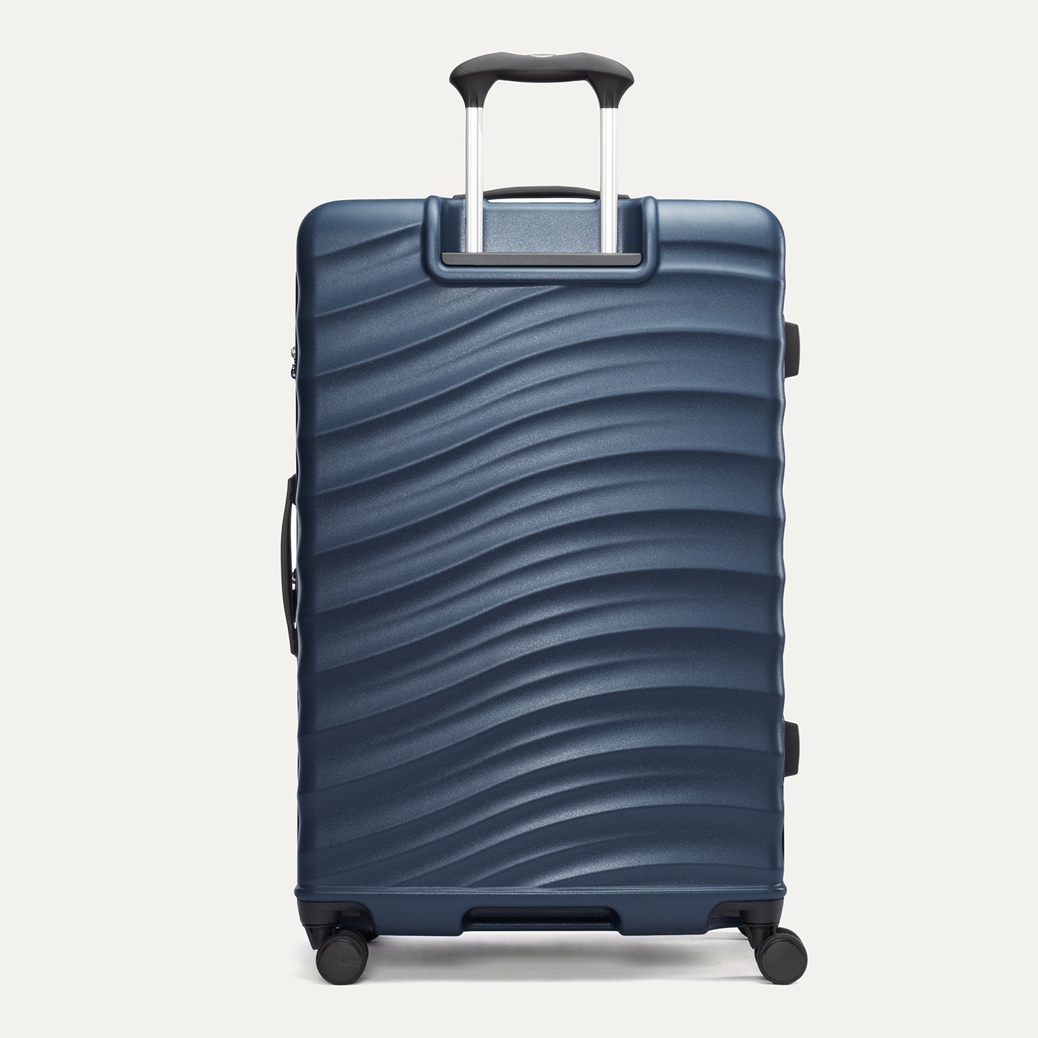 rear view of the large midnight blue travelpro maxlite® air v2 hardside spinner, showing the durable polycarbonate shell with its signature wave design and the powerscope lite extension handle fully deployed.