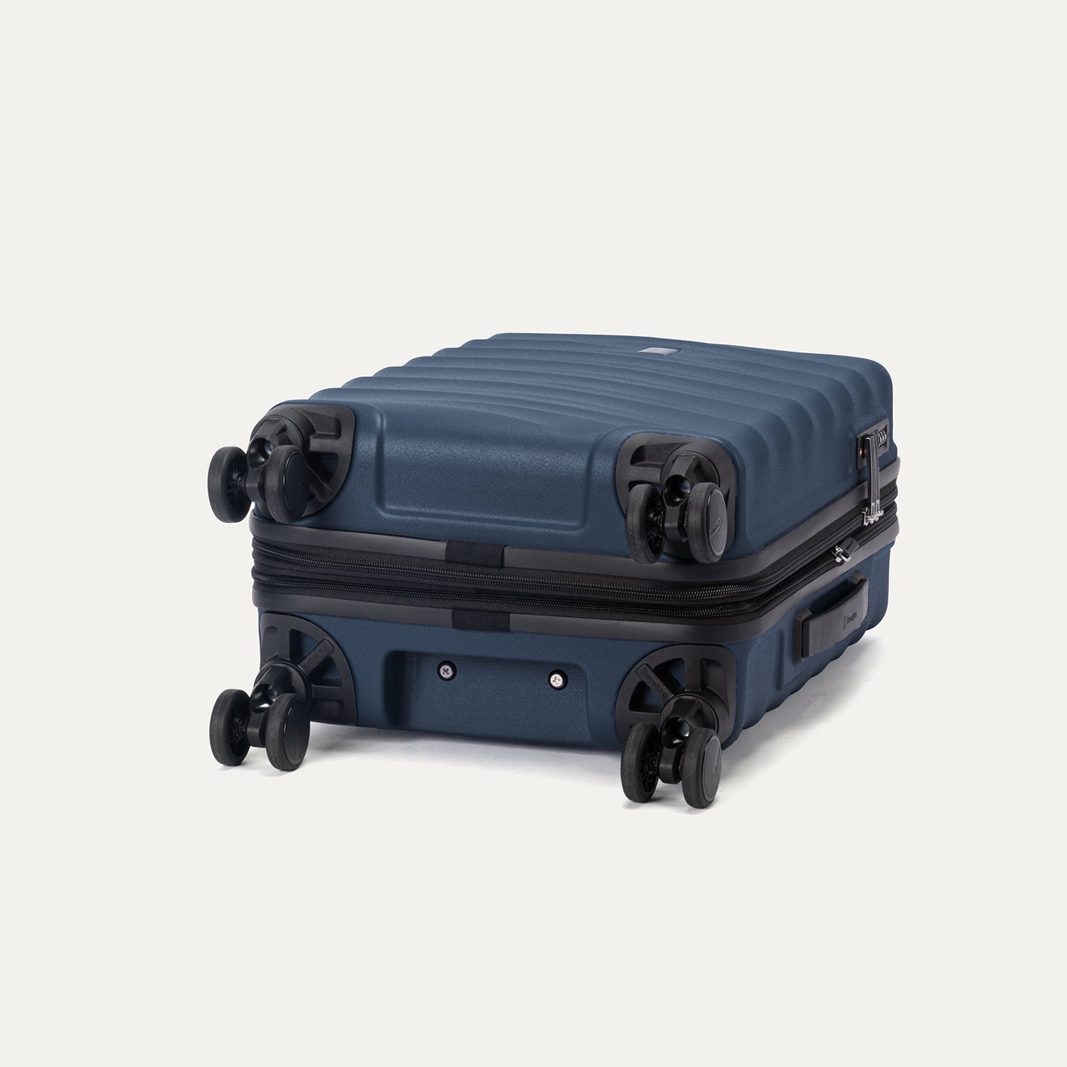 bottom view of the midnight blue travelpro maxlite® air v2 hardside spinner, showing the four smooth-rolling 360-degree wheels and the durable polycarbonate base.