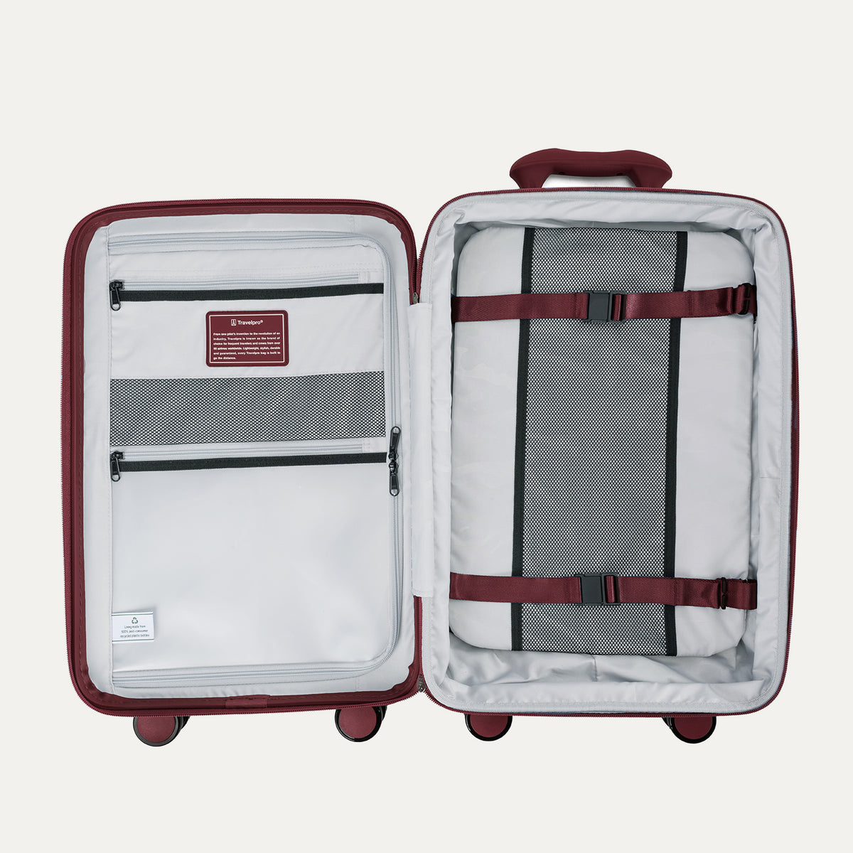 interior view of the open tibetan red travelpro optima® hardside carry-on, showing the organized packing system with a zippered divider panel, mesh pockets, and red compression straps over the main compartment.