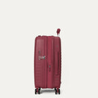 side profile view of the tibetan red travelpro optima® expandable compact carry-on hardside spinner, shown with the zippered expansion feature fully open to provide additional packing capacity.