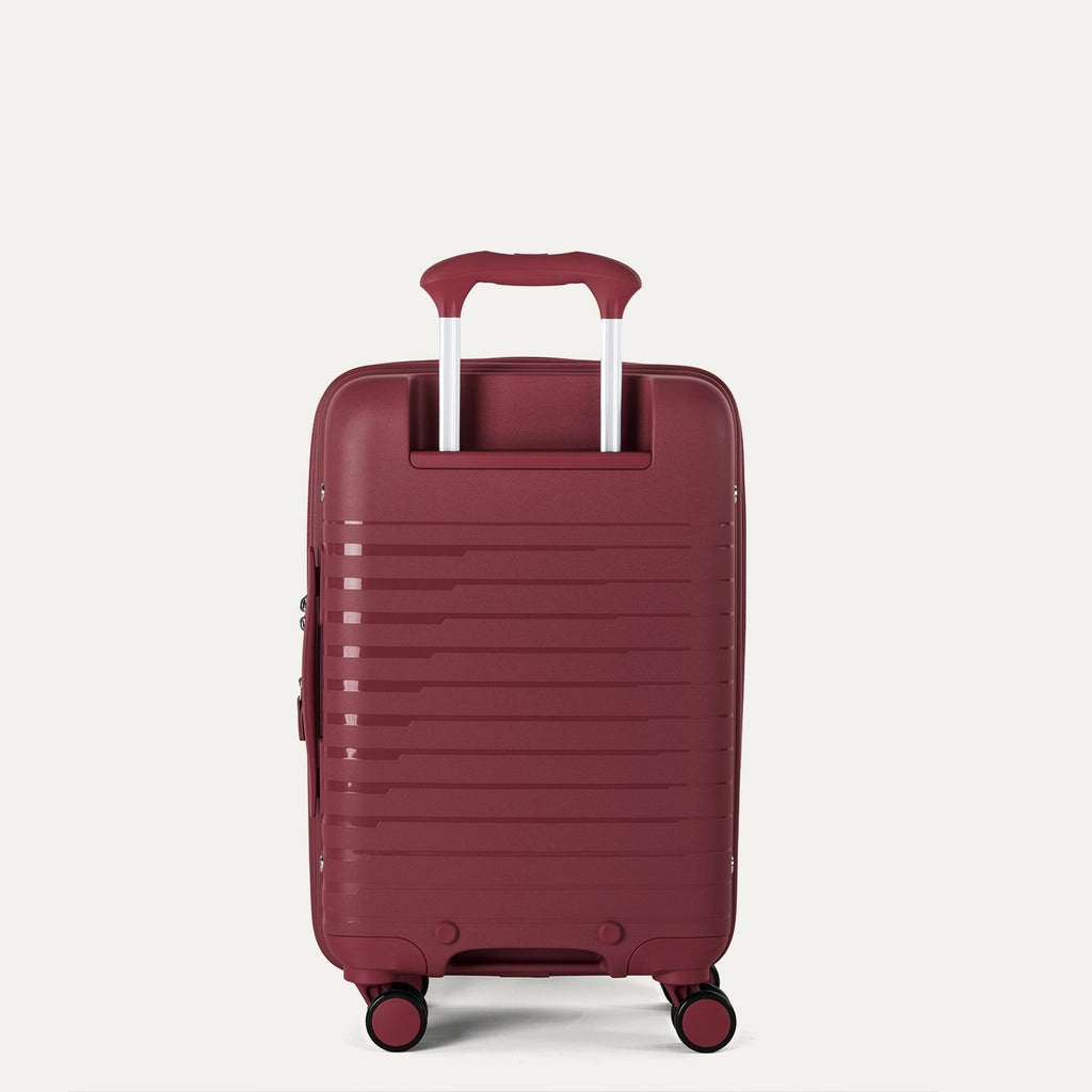 rear view of the tibetan red travelpro optima® expandable compact carry-on hardside spinner, showing the textured polypropylene shell and the color-matched powerscope lite extension handle.