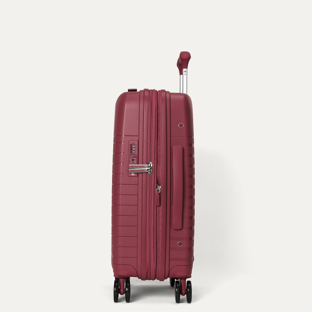 side profile view of the tibetan red travelpro optima® expandable compact carry-on hardside spinner, highlighting the integrated tsa-approved combination lock, flush-mount side carry handle, and the zippered expansion seam.