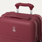 close-up view of the top of the tibetan red travelpro optima® hardside compact carry-on, showing the color-matched cushioned carry handle, the travelpro logo badge on the shell, and the powerscope lite extension handle.