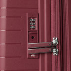 close-up view of the integrated tsa-approved combination lock on the tibetan red travelpro optima® hardside compact carry-on, showing the color-matched lock housing and metal zipper pulls securely locked into place.