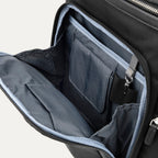 interior view of the front organizational compartment of the black travelpro platinum elite business laptop backpack 27l, showing built-in pockets for pens, a key tether, and a small zippered security pocket.