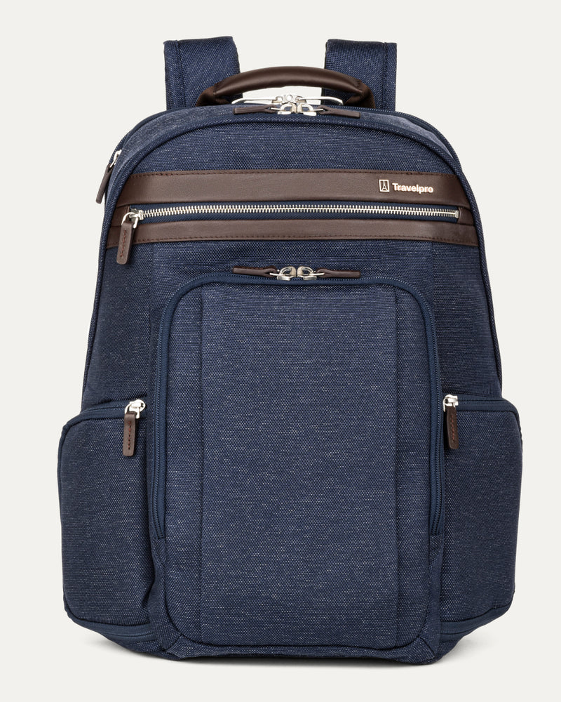 front-facing hero view of the true navy travelpro platinum elite business laptop backpack 27l, featuring a navy blue high-density fabric exterior with premium dark brown leather trim on the pockets and top handle.