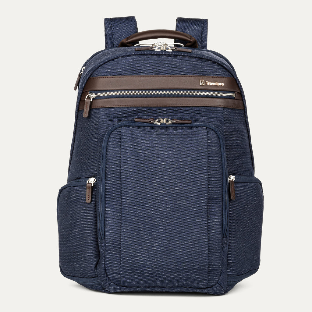 front-facing hero view of the true navy travelpro platinum elite business laptop backpack 27l, featuring a navy blue high-density fabric exterior with premium dark brown leather trim on the pockets and top handle.