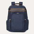 front-facing hero view of the true navy travelpro platinum elite business laptop backpack 27l, featuring a navy blue high-density fabric exterior with premium dark brown leather trim on the pockets and top handle.