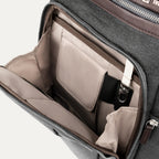 interior view of the front organizational compartment of the vintage grey travelpro platinum elite business laptop backpack 27l, showing built-in pockets for pens, a key tether, and a small zippered security pocket.