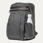 side view of the vintage grey travelpro platinum elite business laptop backpack 27l, showing a white reusable water bottle tucked into the integrated side pocket with dark brown leather trim.