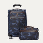 a 2-piece travel luggage set in navy blue camouflage featuring the travelpro platinum elite 21-inch carry-on spinner and the matching underseat tote bag, shown with premium brown leather accents and chrome hardware.