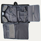 full interior view of the shadow black travelpro platinum® elite carry-on rolling garment bag opened flat, showing the grey patterned lining, multiple mesh organizational pockets, and a fold-out extension panel for longer garments.
