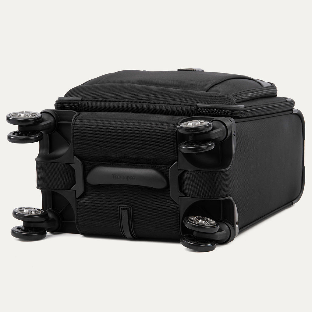 bottom view of the shadow black travelpro platinum® elite carry-on spinner tote, showing the four high-performance magnatrac® self-aligning spinner wheels, the protective bottom molding, and the durable fabric construction.
